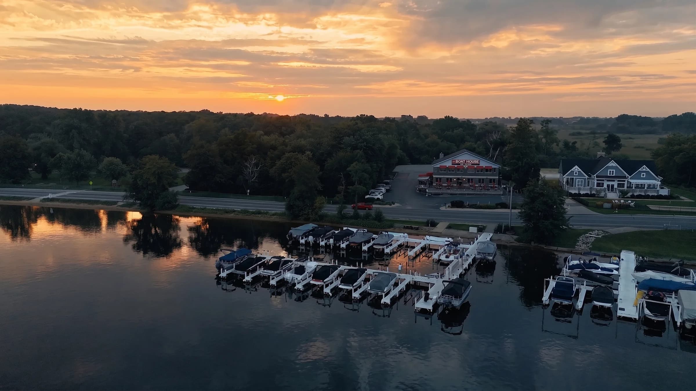 Aerial view of The Boat House Bar & Grill on Geneva Lake at golden hour