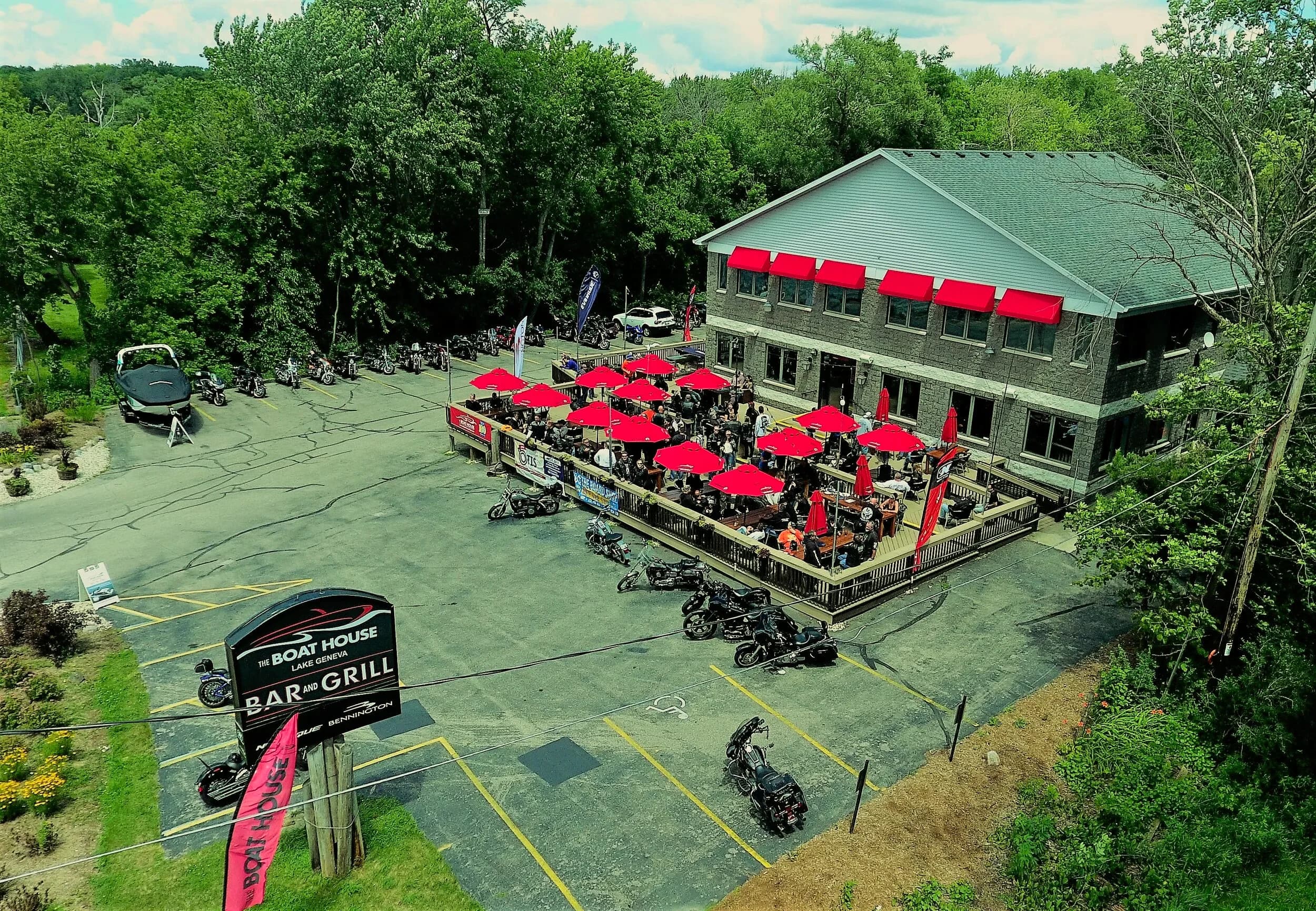 A full deck under red umbrellas at The Boat House Bar & Grill