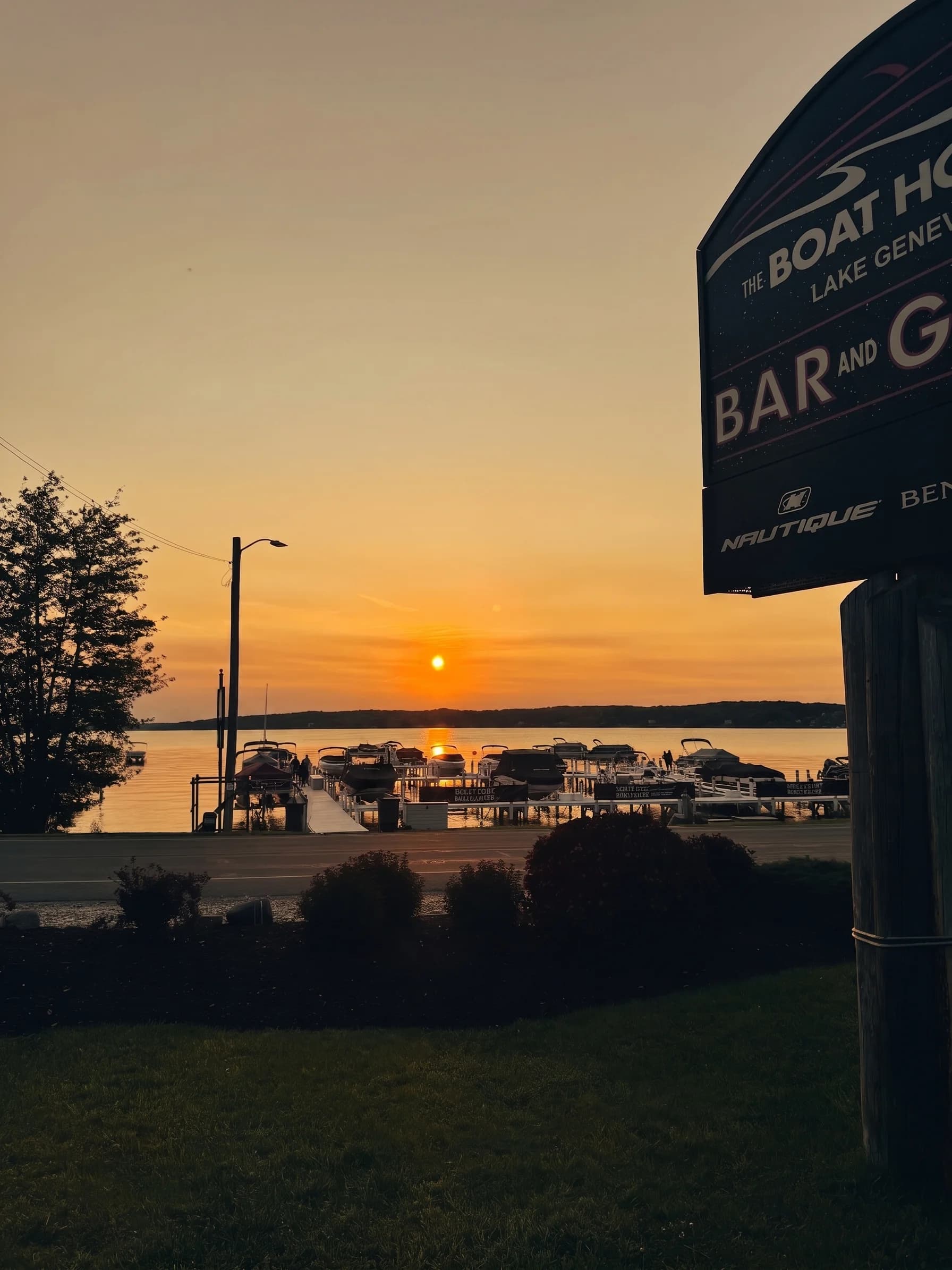 The Boat House Bar & Grill sign at sunset on Geneva Lake