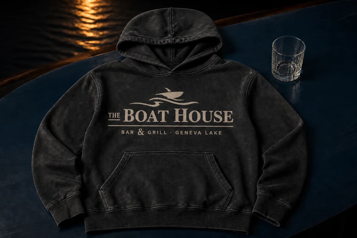 A washed-charcoal heavyweight hoodie with the complete one-color Boat House lockup printed into the fabric.