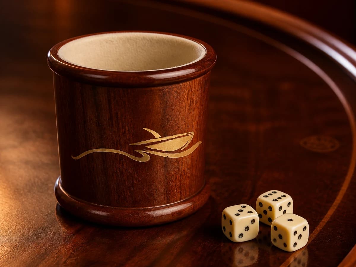 Varnished mahogany dice cup with the boat-and-water mark.